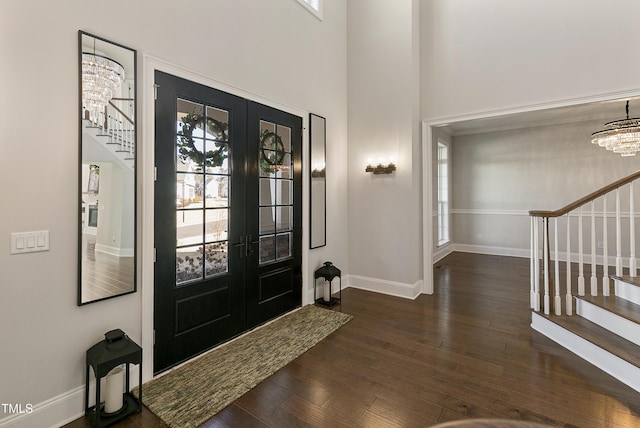 1475 Sierra Glen Cir, Apex, NC 27502 - foyer featuring stairs, a chandelier, french doors, wood finished floors, and a high ceiling