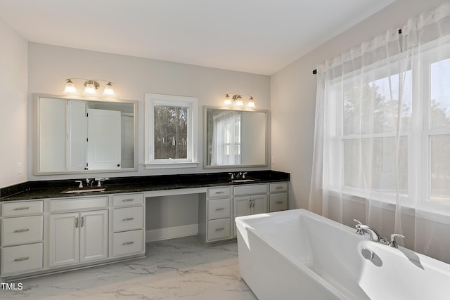 1475 Sierra Glen Cir, Apex, NC 27502 - bathroom featuring marble look tiles, a freestanding bath, and double vanity