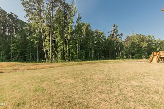 1475 Sierra Glen Cir, Apex, NC 27502 - view of grassy yard featuring stairway and a view of trees