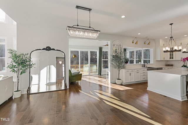 1475 Sierra Glen Cir, Apex, NC 27502 - kitchen featuring a chandelier, a sink, recessed lighting, light countertops, and white cabinets