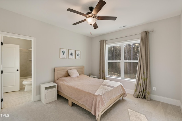1475 Sierra Glen Cir, Apex, NC 27502 - bedroom featuring light colored carpet, baseboards, ensuite bath, and ceiling fan