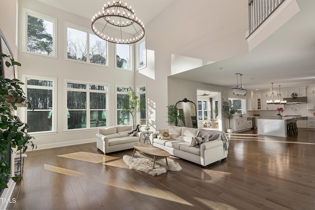 1475 Sierra Glen Cir, Apex, NC 27502 - living area featuring a chandelier, a high ceiling, and dark wood-style flooring
