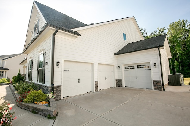 1475 Sierra Glen Cir, Apex, NC 27502 - view of property exterior with stone siding, concrete driveway, an attached garage, and roof with shingles