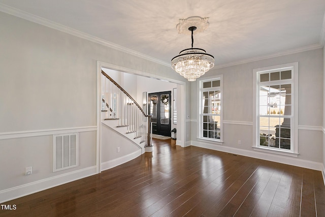 1475 Sierra Glen Cir, Apex, NC 27502 - spare room with stairs, a chandelier, baseboards, ornamental molding, and dark wood-style floors
