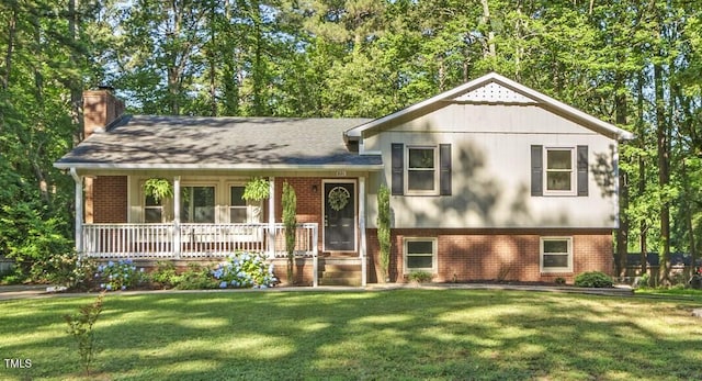 821 Stoneybrook Dr, Sanford, NC 27330 - split level home featuring brick siding, a chimney, covered porch, and a front yard