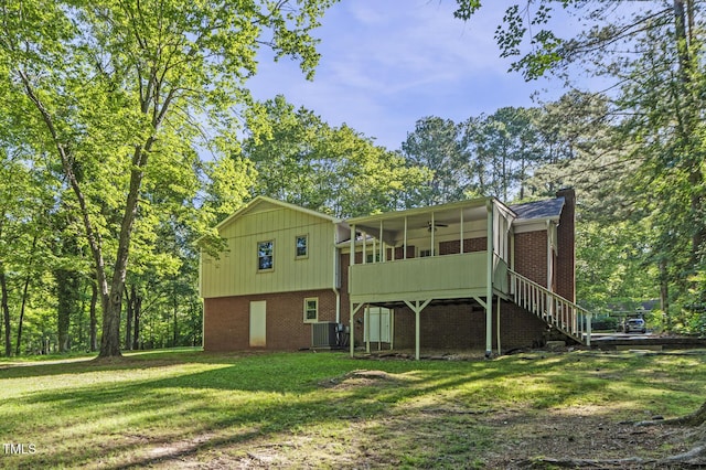 821 Stoneybrook Dr, Sanford, NC 27330 - rear view of property featuring a sunroom, a chimney, a yard, ceiling fan, and brick siding
