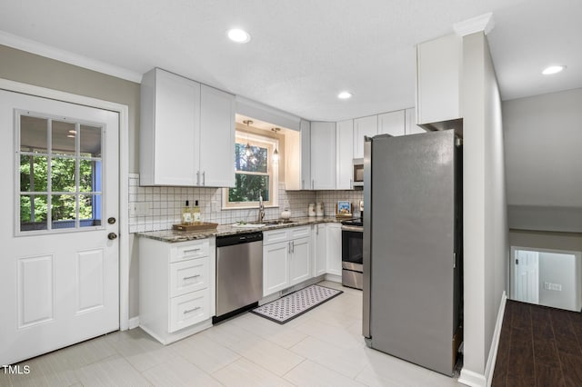 821 Stoneybrook Dr, Sanford, NC 27330 - kitchen featuring stainless steel appliances, a sink, dark stone counters, white cabinets, and decorative backsplash