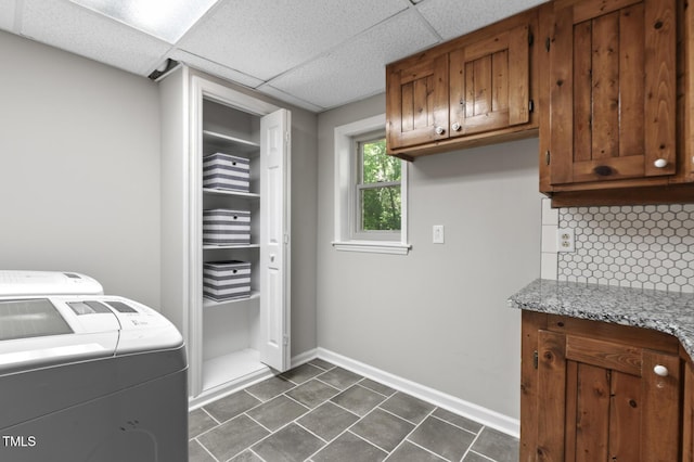 821 Stoneybrook Dr, Sanford, NC 27330 - laundry room featuring washing machine and dryer, cabinet space, baseboards, and dark tile patterned flooring