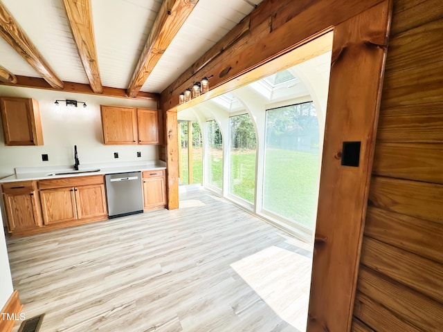 1283 Ennis Rd, Angier, NC 27501 - kitchen with dishwasher, a sink, light wood finished floors, beamed ceiling, and light countertops
