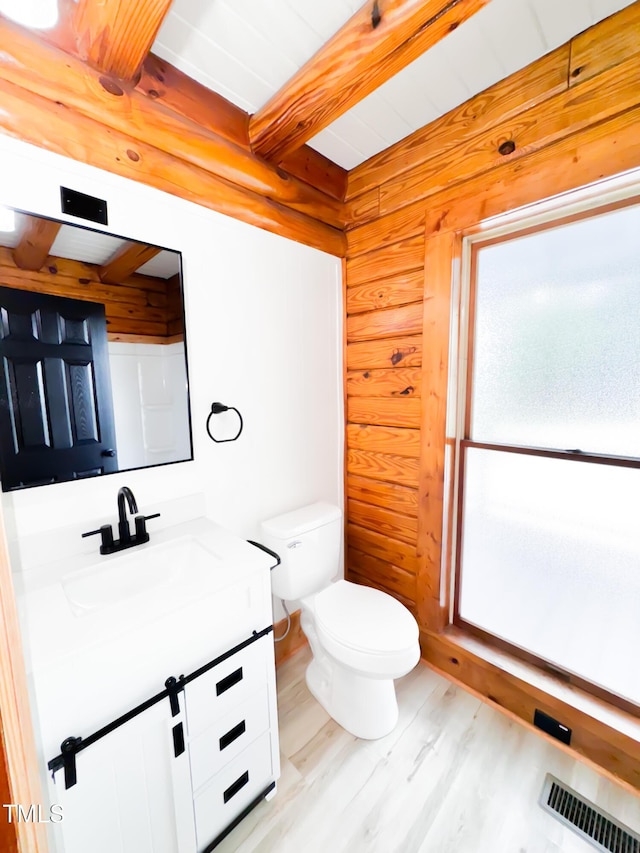 1283 Ennis Rd, Angier, NC 27501 - bathroom featuring vanity, wood finished floors, toilet, and beam ceiling