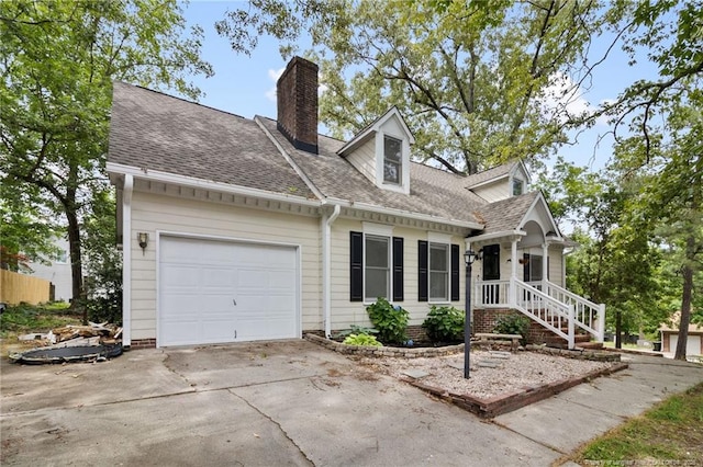 1266 Exeter Ln, Fayetteville, NC 28314 - new england style home with a chimney, driveway, an attached garage, and a shingled roof