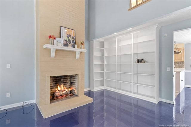 1266 Exeter Ln, Fayetteville, NC 28314 - unfurnished living room featuring a lit fireplace, built in features, and baseboards
