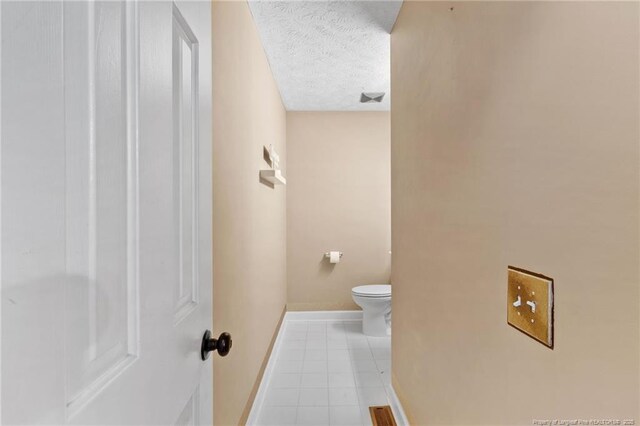 1266 Exeter Ln, Fayetteville, NC 28314 - bathroom with toilet, baseboards, tile patterned flooring, and a textured ceiling