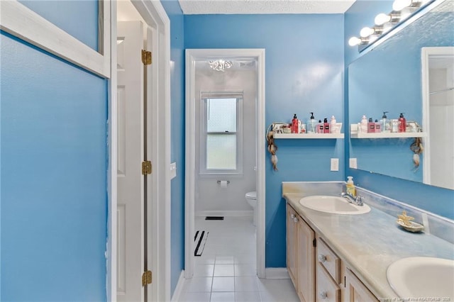 1266 Exeter Ln, Fayetteville, NC 28314 - bathroom with tile patterned floors, double vanity, baseboards, and toilet