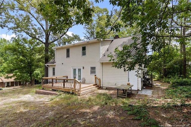 1266 Exeter Ln, Fayetteville, NC 28314 - rear view of house featuring french doors, a wooden deck, a shingled roof, and a chimney