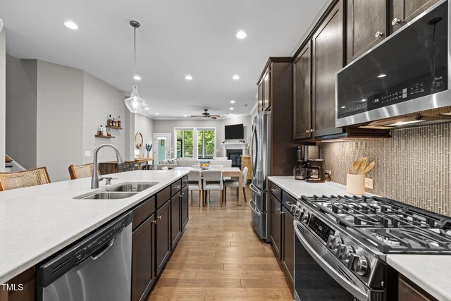 78 Salt Cedar Ln, Chapel Hill, NC 27516 - kitchen with stainless steel appliances, a sink, dark brown cabinets, recessed lighting, and ceiling fan