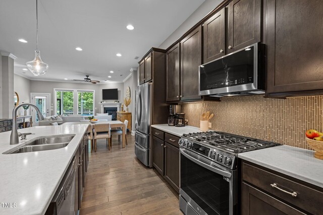 78 Salt Cedar Ln, Chapel Hill, NC 27516 - kitchen featuring stainless steel appliances, a sink, ceiling fan, open floor plan, and ornamental molding