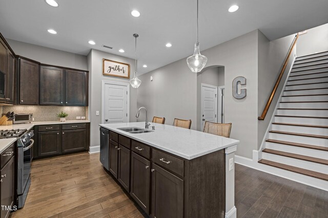78 Salt Cedar Ln, Chapel Hill, NC 27516 - kitchen with a sink, gas stove, dark brown cabinets, dark wood finished floors, and recessed lighting