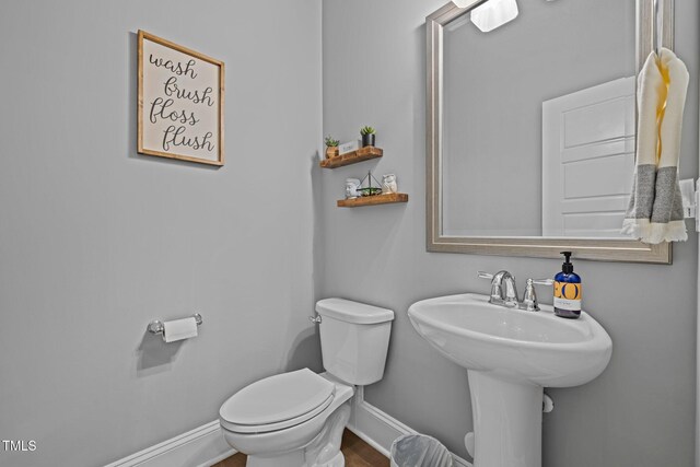 78 Salt Cedar Ln, Chapel Hill, NC 27516 - bathroom with baseboards, toilet, and wood finished floors