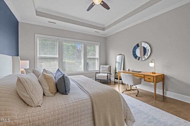 78 Salt Cedar Ln, Chapel Hill, NC 27516 - bedroom with wood finished floors, a tray ceiling, ornamental molding, baseboards, and a ceiling fan