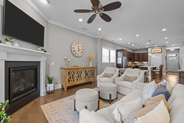 78 Salt Cedar Ln, Chapel Hill, NC 27516 - living area featuring crown molding, recessed lighting, a ceiling fan, baseboards, and a glass covered fireplace