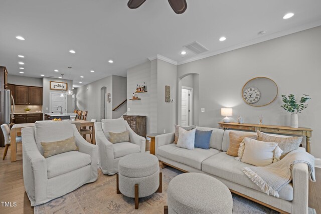 78 Salt Cedar Ln, Chapel Hill, NC 27516 - living area featuring arched walkways, recessed lighting, light wood finished floors, crown molding, and a ceiling fan