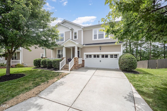 1211 Whispering Oak Ln, Durham, NC 27704 - view of front of property featuring a garage, concrete driveway, and covered porch
