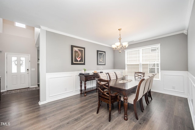 1211 Whispering Oak Ln, Durham, NC 27704 - dining room featuring a chandelier, crown molding, wainscoting, dark wood-type flooring, and a decorative wall
