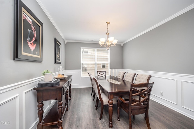 1211 Whispering Oak Ln, Durham, NC 27704 - dining room featuring a chandelier, ornamental molding, dark wood-style flooring, wainscoting, and a decorative wall