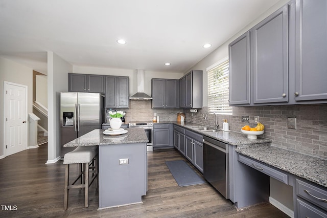 1211 Whispering Oak Ln, Durham, NC 27704 - kitchen with stainless steel appliances, wall chimney range hood, gray cabinetry, a kitchen island, and a sink