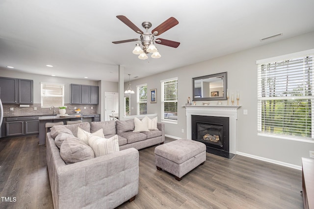 1211 Whispering Oak Ln, Durham, NC 27704 - living room with dark wood finished floors, ceiling fan, a glass covered fireplace, baseboards, and recessed lighting