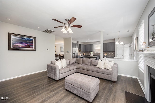 1211 Whispering Oak Ln, Durham, NC 27704 - living room with a ceiling fan, dark wood-style flooring, baseboards, recessed lighting, and a chandelier