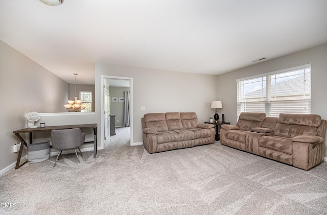 1211 Whispering Oak Ln, Durham, NC 27704 - living room featuring a chandelier, carpet, and baseboards