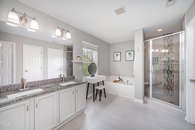 1211 Whispering Oak Ln, Durham, NC 27704 - full bath featuring a bath, a stall shower, and double vanity
