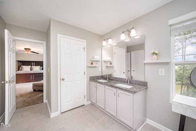 1211 Whispering Oak Ln, Durham, NC 27704 - ensuite bathroom with baseboards, double vanity, and ceiling fan