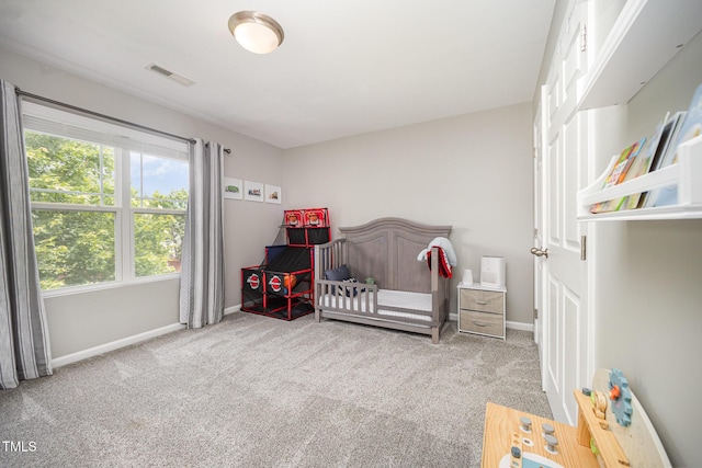 1211 Whispering Oak Ln, Durham, NC 27704 - bedroom with carpet flooring, baseboards, and a nursery area