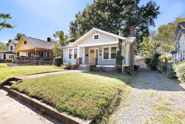 409 N Hyde Park Ave, Durham, NC 27703 - bungalow-style home featuring covered porch, a chimney, and driveway