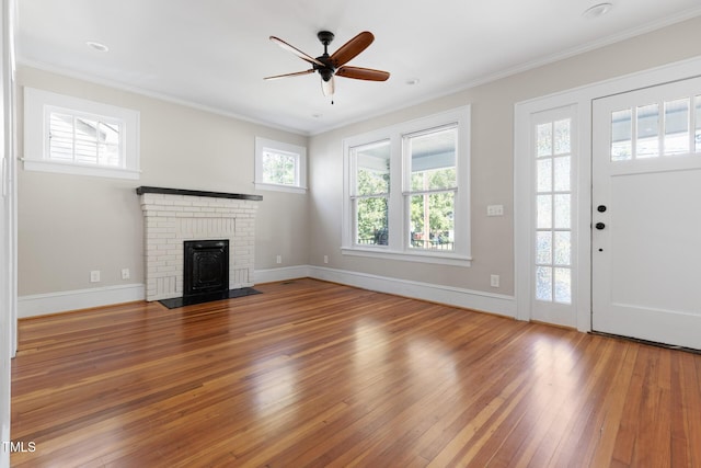 409 N Hyde Park Ave, Durham, NC 27703 - unfurnished living room featuring hardwood / wood-style floors, a ceiling fan, crown molding, baseboards, and a brick fireplace