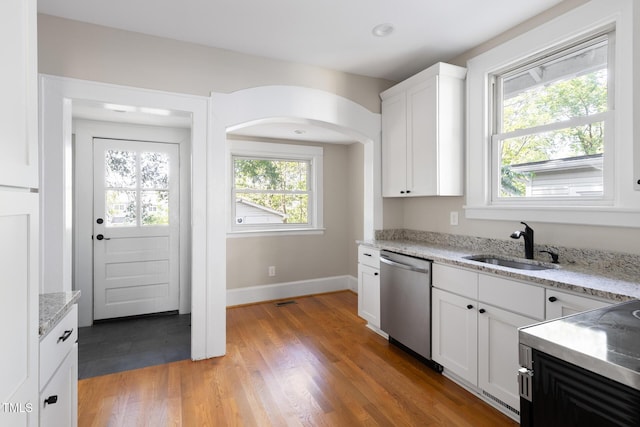 409 N Hyde Park Ave, Durham, NC 27703 - kitchen featuring dishwasher, a sink, baseboards, white cabinetry, and light stone countertops