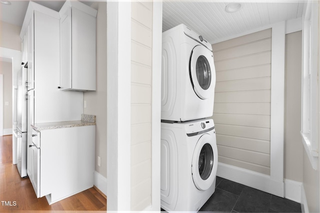 409 N Hyde Park Ave, Durham, NC 27703 - washroom featuring stacked washer and clothes dryer, baseboards, and dark wood-style floors