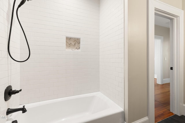 409 N Hyde Park Ave, Durham, NC 27703 - bathroom with baseboards, shower / bathtub combination, and wood finished floors