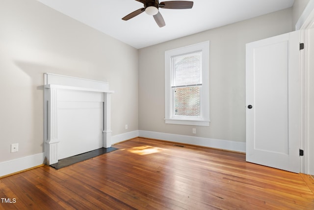 409 N Hyde Park Ave, Durham, NC 27703 - unfurnished bedroom featuring baseboards, hardwood / wood-style floors, and a ceiling fan