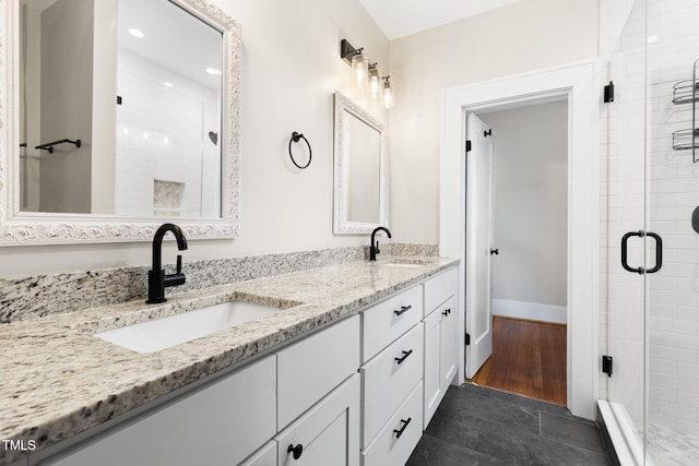 409 N Hyde Park Ave, Durham, NC 27703 - full bath featuring a shower stall, double vanity, recessed lighting, and baseboards