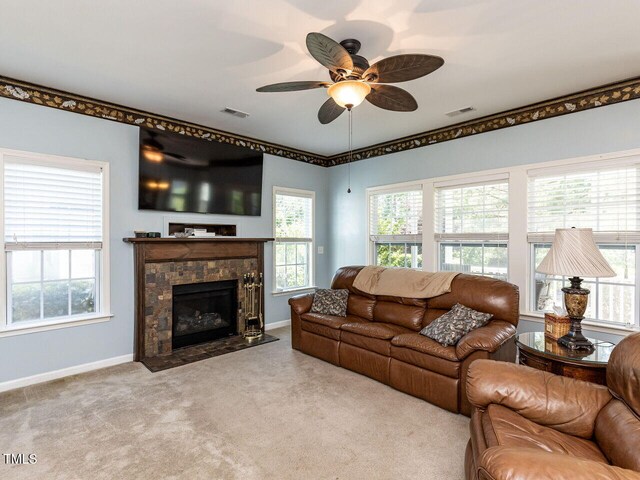 1004 Bridlemine Dr, Fuquay Varina, NC 27526 - living area with carpet, ceiling fan, baseboards, and a stone fireplace