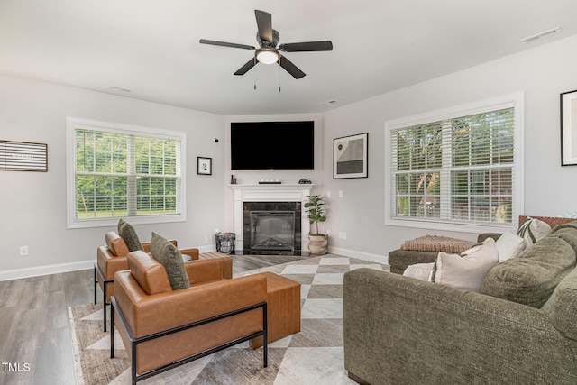 108 Pointe Dr, La Grange, NC 28551 - living area with a ceiling fan, light wood-type flooring, a tiled fireplace, and baseboards