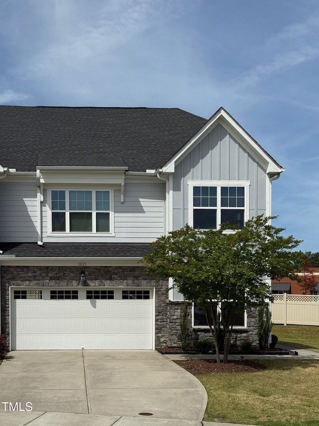 1021 Benay Rd, Morrisville, NC 27560 - view of front of house featuring an attached garage, concrete driveway, board and batten siding, and stone siding