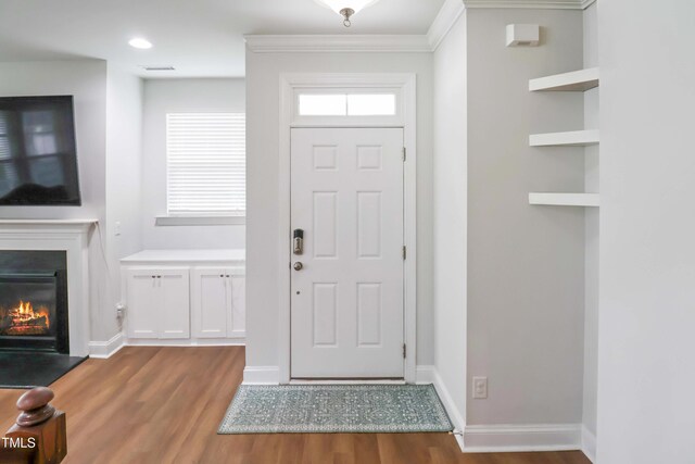 1021 Benay Rd, Morrisville, NC 27560 - foyer featuring wood finished floors, a glass covered fireplace, ornamental molding, and baseboards