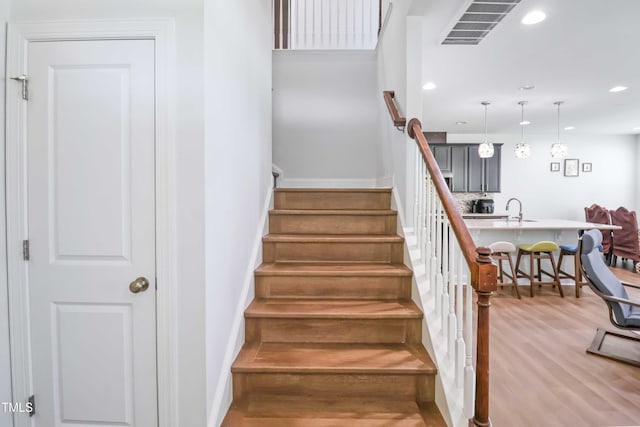 1021 Benay Rd, Morrisville, NC 27560 - stairs featuring wood finished floors, baseboards, and recessed lighting