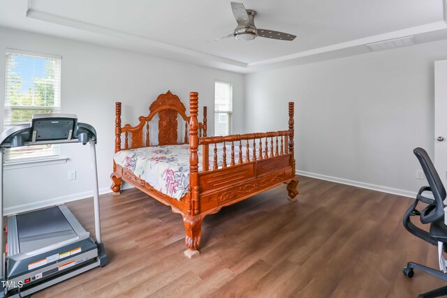1021 Benay Rd, Morrisville, NC 27560 - bedroom with wood finished floors, a tray ceiling, and baseboards