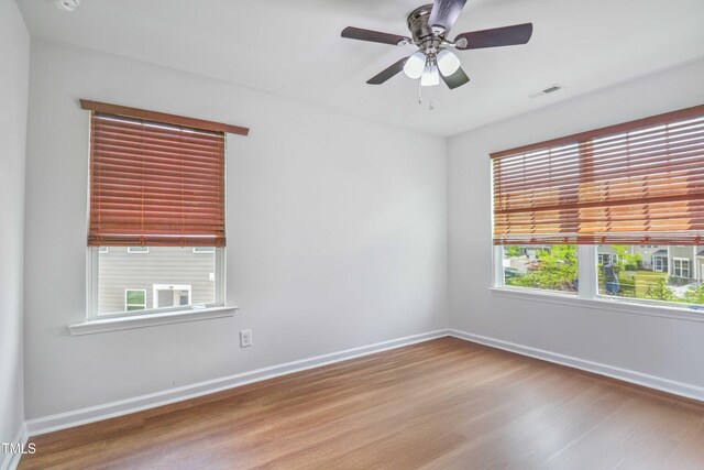 1021 Benay Rd, Morrisville, NC 27560 - spare room with baseboards, wood finished floors, and ceiling fan